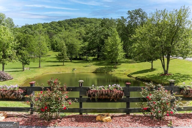 view of property's community featuring a water view and a yard