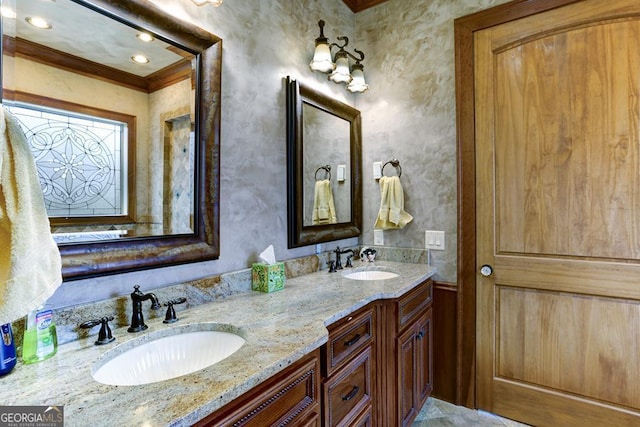 bathroom featuring crown molding and vanity