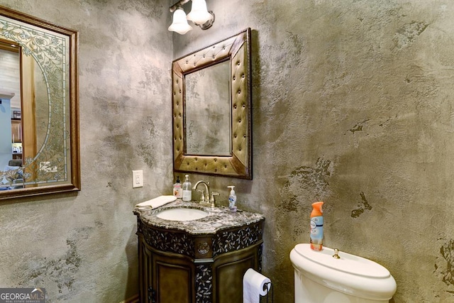 bathroom featuring toilet and vanity