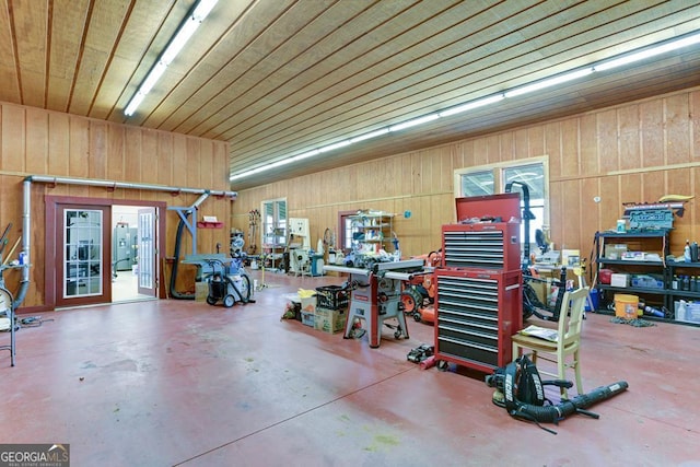 garage featuring a workshop area and wood walls