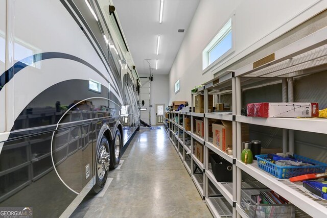 interior space featuring a high ceiling and concrete flooring