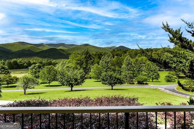 view of home's community featuring a mountain view and a lawn