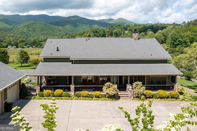 exterior space featuring covered porch and a mountain view