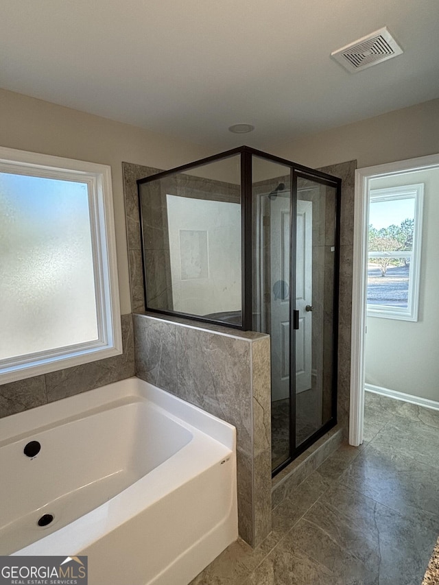 bathroom featuring a garden tub, a shower stall, and visible vents