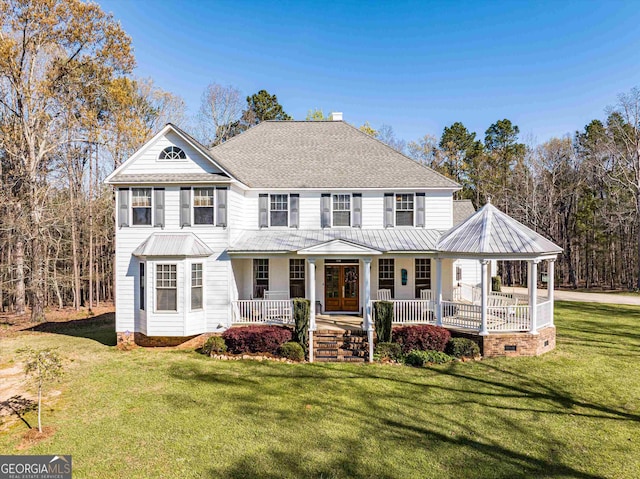 view of front of home with a front yard and covered porch