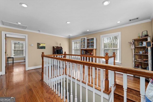 hall with ornamental molding and dark hardwood / wood-style floors