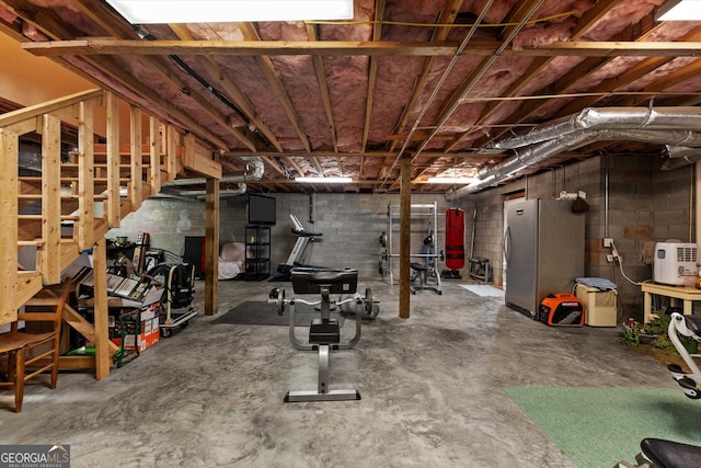 basement featuring stainless steel fridge