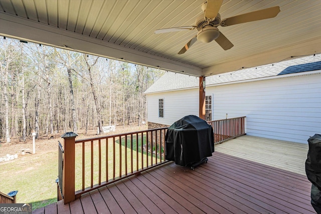 wooden terrace with ceiling fan and grilling area