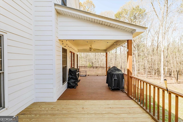 wooden deck featuring a grill