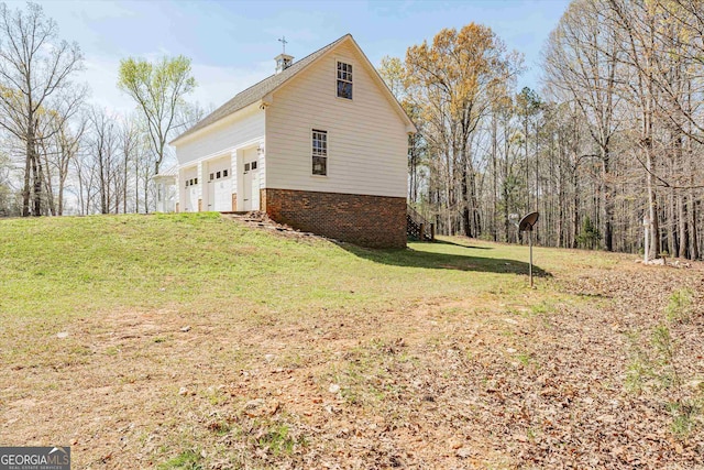 view of property exterior featuring a lawn and a garage