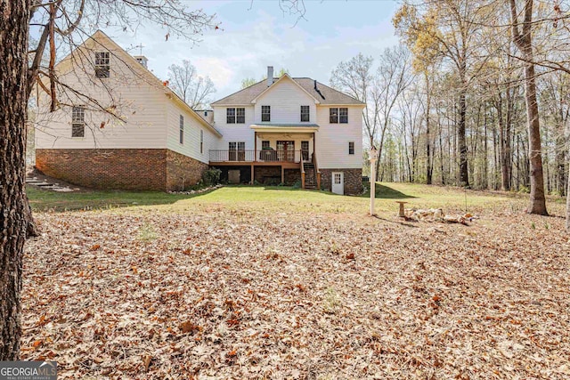 rear view of house with a lawn