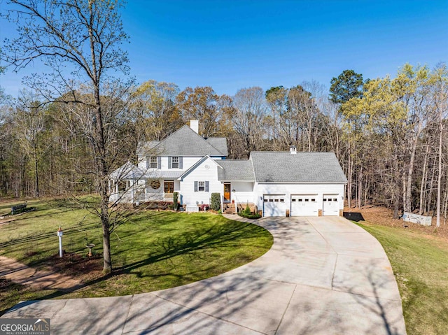 view of front of property with a garage and a front lawn