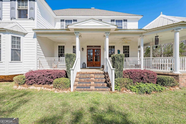 view of front facade featuring covered porch and a front yard