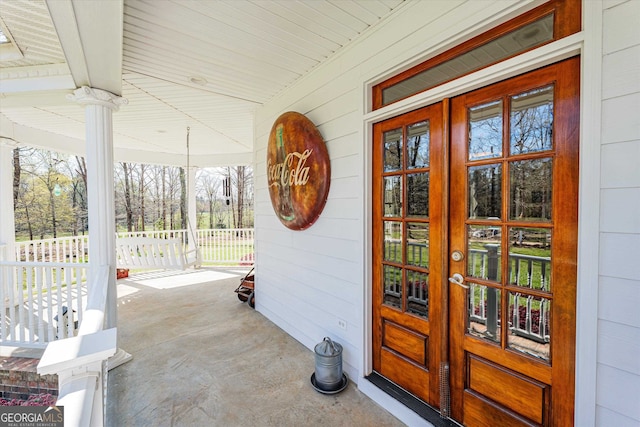 doorway to property featuring covered porch