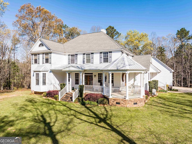 view of front facade featuring a front yard and covered porch