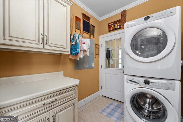 laundry room with cabinets, ornamental molding, stacked washer and dryer, and light tile flooring