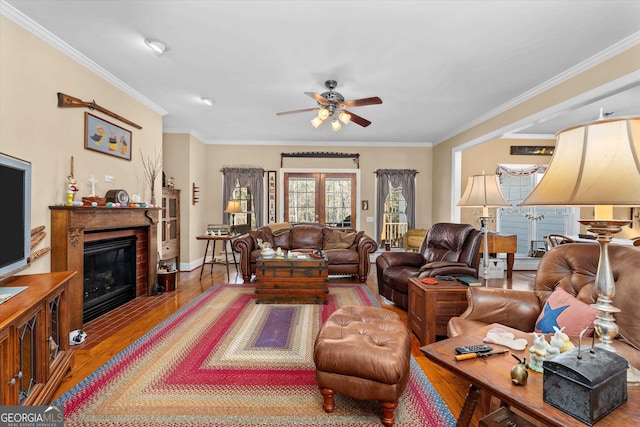 living room with ornamental molding, dark hardwood / wood-style flooring, and ceiling fan