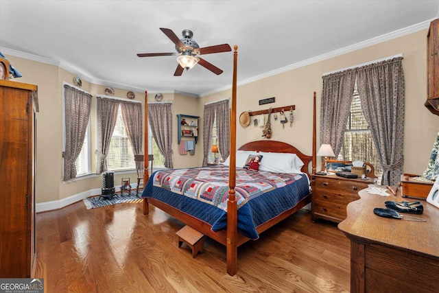 bedroom featuring ceiling fan, crown molding, and light wood-type flooring