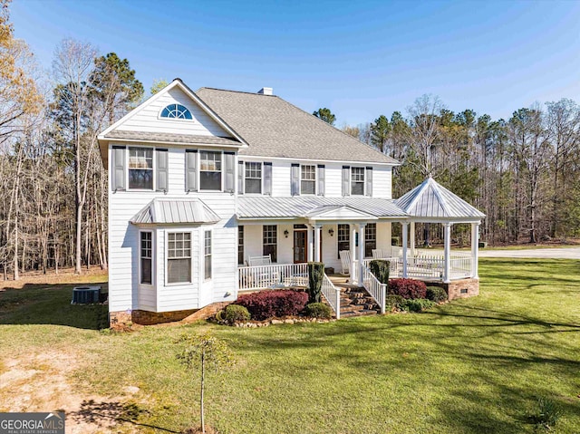 view of front of property featuring a front yard, a porch, and central air condition unit