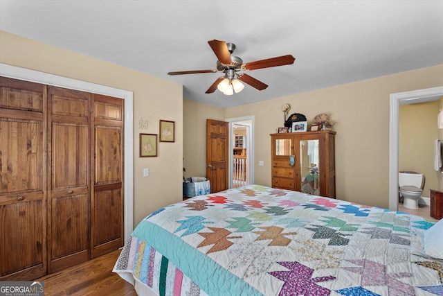 bedroom with a closet, ceiling fan, hardwood / wood-style flooring, and connected bathroom