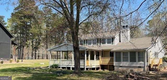 rear view of house featuring a yard