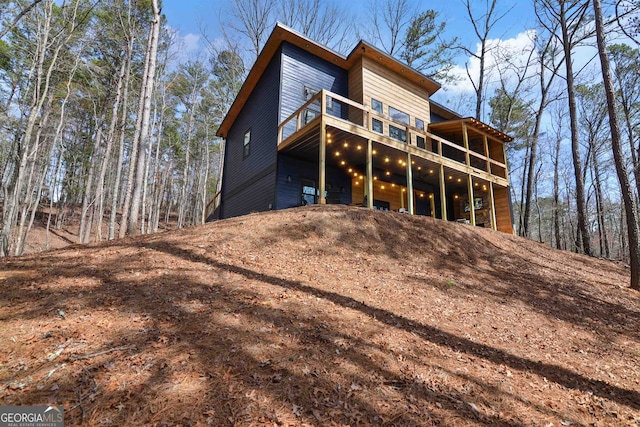 rear view of property featuring a balcony