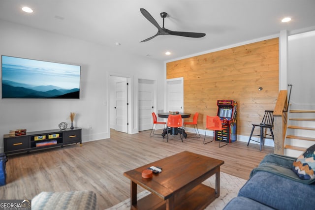 living room featuring ceiling fan and light wood-type flooring