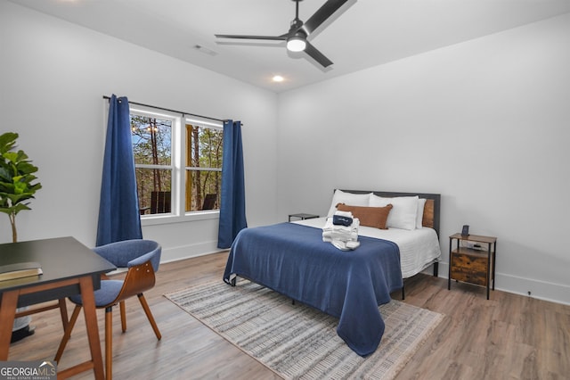 bedroom with ceiling fan and wood-type flooring