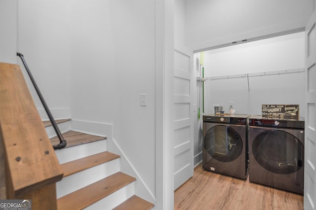 washroom featuring light wood-type flooring, washer and dryer, and hookup for a washing machine