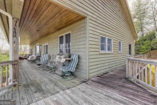 wooden deck with a grill