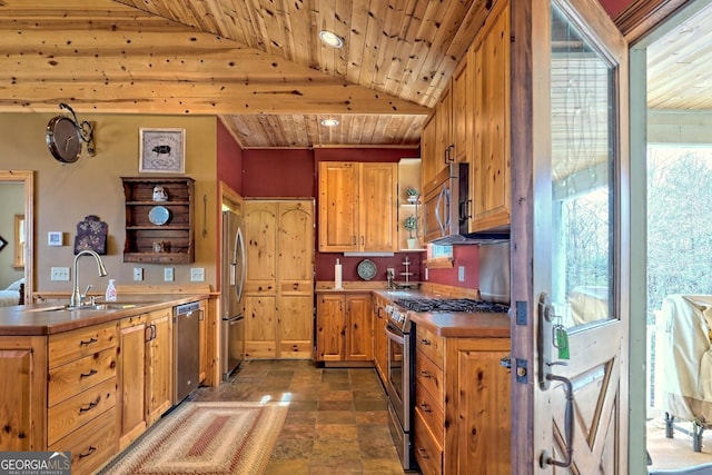 kitchen with appliances with stainless steel finishes, wood ceiling, sink, and lofted ceiling