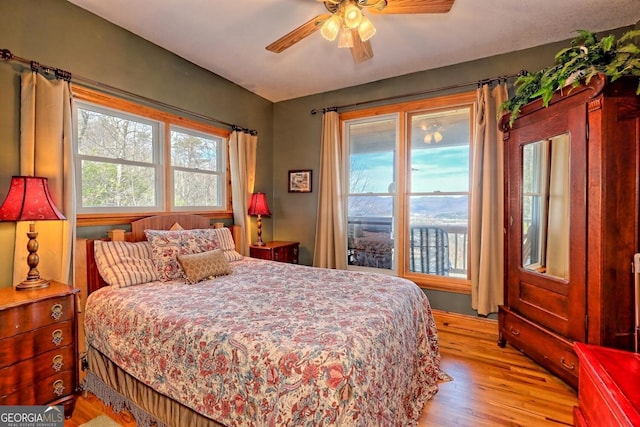 bedroom with light hardwood / wood-style floors and ceiling fan