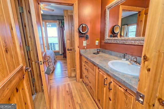 bathroom featuring vanity, hardwood / wood-style floors, plenty of natural light, and ceiling fan