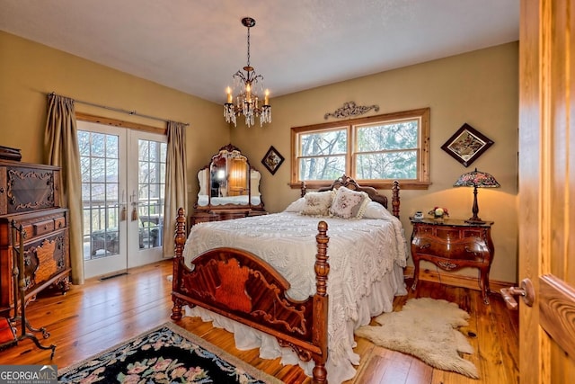 bedroom with access to outside, multiple windows, french doors, and light wood-type flooring