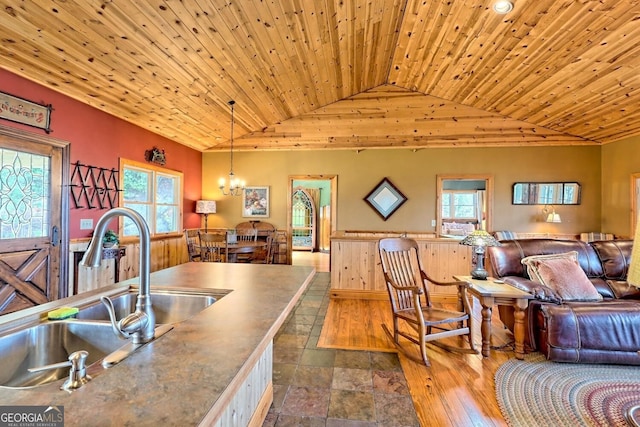 kitchen featuring a wealth of natural light, wooden ceiling, and pendant lighting