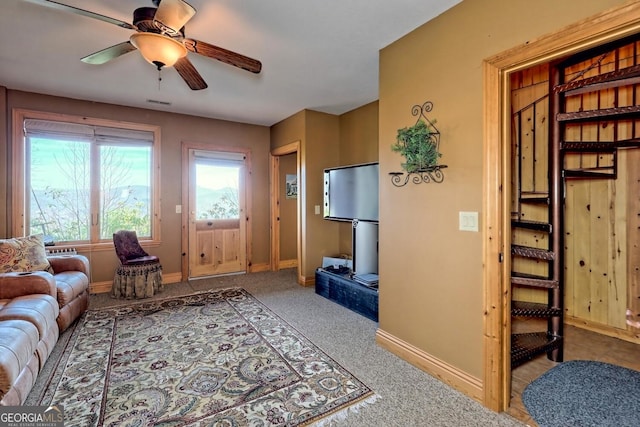 carpeted living room featuring ceiling fan