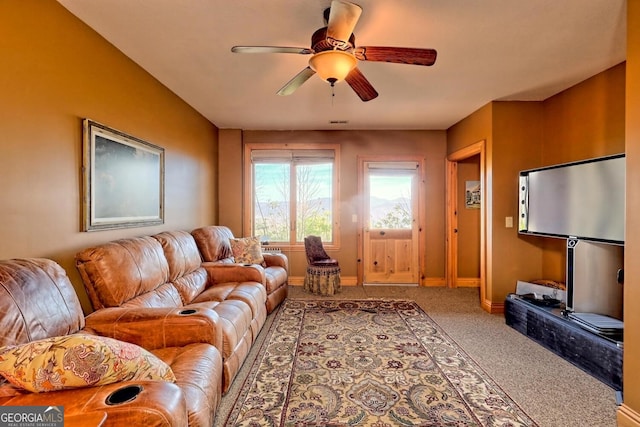 carpeted living room featuring ceiling fan