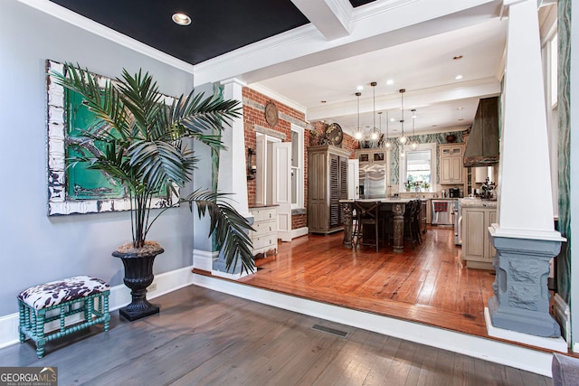 dining room with ornamental molding, dark hardwood / wood-style floors, and ornate columns