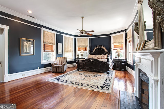 bedroom with ornamental molding, dark wood-type flooring, and a fireplace