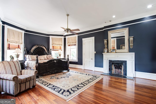 bedroom featuring ceiling fan, crown molding, and dark hardwood / wood-style floors