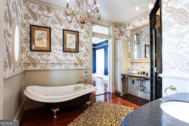 bathroom featuring a bathtub, vanity, a healthy amount of sunlight, and hardwood / wood-style floors