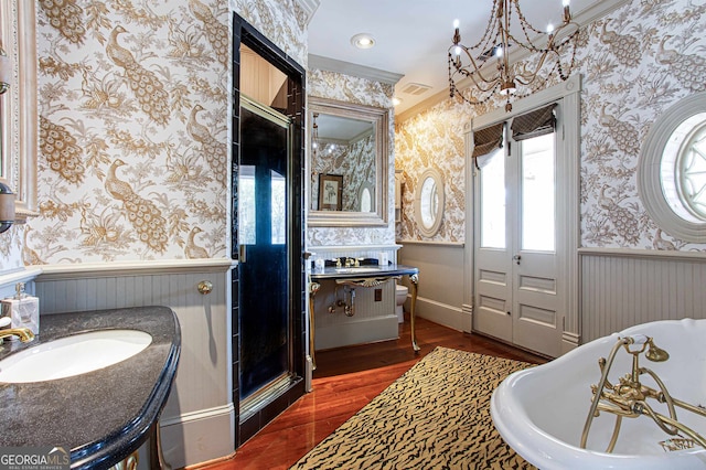 bathroom with hardwood / wood-style floors, a wealth of natural light, vanity, and a bath