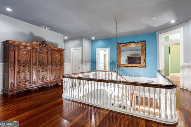 corridor with dark hardwood / wood-style flooring