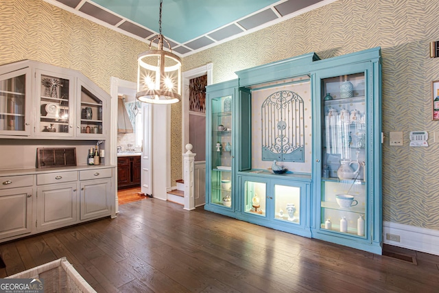 kitchen with a chandelier, dark hardwood / wood-style flooring, white cabinets, and hanging light fixtures