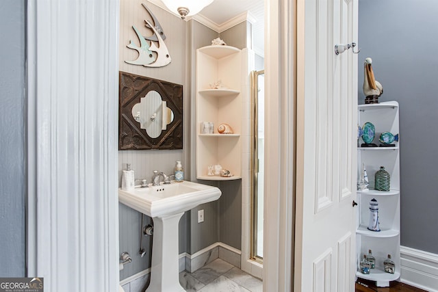 bathroom with ornamental molding, tile floors, and sink