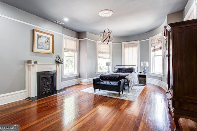 bedroom with a notable chandelier and hardwood / wood-style flooring