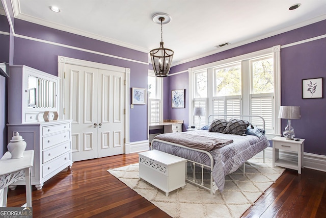 bedroom featuring crown molding, a notable chandelier, and wood-type flooring