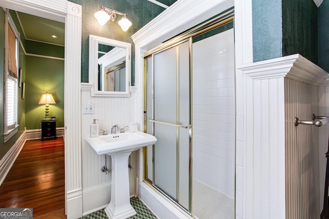 bathroom featuring a shower with door and hardwood / wood-style floors