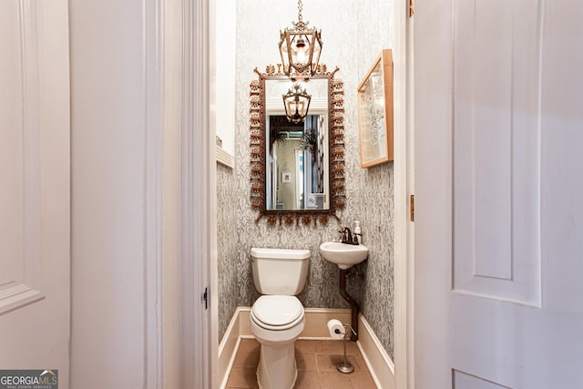 bathroom featuring tile flooring and toilet