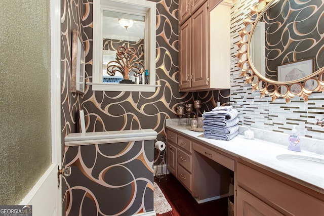 bathroom featuring backsplash, vanity, and wood-type flooring